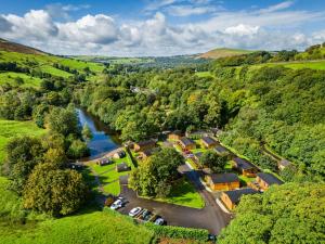 an aerial view of a village with a river at Lakeside Pods - pets welcome in Oldham +13 photos