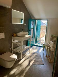 a bathroom with a sink and a toilet at Blue Dream in Murvica +98 photos