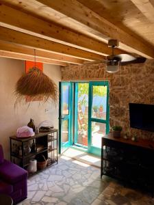 a living room with a blue door and a tv at Blue Dream in Murvica