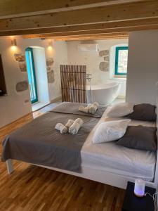 a bedroom with two beds and a bath tub at Blue Dream in Murvica