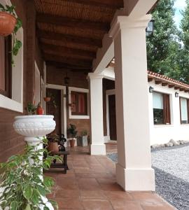 a porch of a house with white columns at El Descanso Cafayate in Cafayate