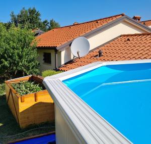 a swimming pool in front of a house at Apartma Istra Zora in Sečovlje