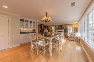 a kitchen with a table and chairs and a living room at The Gardens - Azalea - Walking distance to Douglas Beach - Private hot tub in Douglas