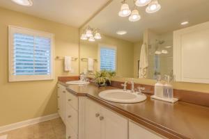 a bathroom with two sinks and a large mirror at The Gardens - Azalea - Walking distance to Douglas Beach - Private hot tub in Douglas +16 photos