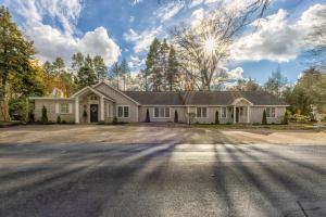a large white house with a driveway at The Gardens - Azalea - Walking distance to Douglas Beach - Private hot tub in Douglas
