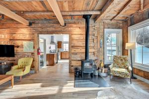 a living room with a fireplace and wooden walls at Historic Home Near Main Street Buena Vista! in Buena Vista