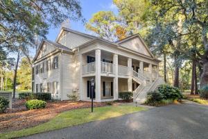 a white house with a porch and a driveway at Golf Side Elegance 2BR Villa Hideaway in Pawleys Island