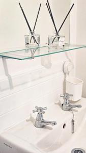 a glass shelf above a bathroom sink at Luxury Room 8min to Sheffield City Center, Free parking in Manor