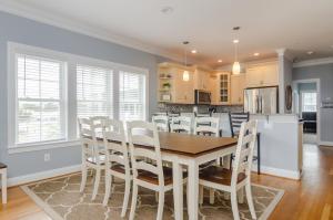 a kitchen and dining room with a table and chairs at The View by Bryant Real Estate in Kure Beach