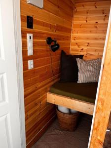 a sauna with a bed in a wooden wall at Fairy tale house during Ski world cup in Melhus