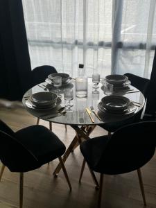 a table with plates and glasses and a candle on it at Ciné &chill in Mulhouse