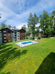 a yard with a swimming pool in front of a building at Departamento en Pucón - Camino al Volcan in Pucón