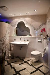 a bathroom with a sink and a toilet and a mirror at HTS Haus Respirada Wellnessarea, Whirlpool, GYM, Sauna in Meckenheim +47 photos