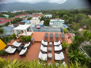 a deck with lounge chairs and a view of the ocean at The Mystery Con Dao in Con Dao