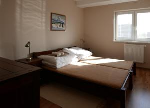 a bedroom with a large bed with a window at Apartment Adriana 10E, Vysoké Tatry, High Tatras in Veľký Slavkov