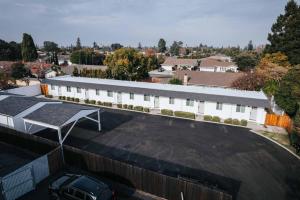 a building with a car parked in a parking lot at Brand New Apt W Parking Blocks From Downtown- C in Sunnyvale