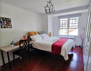 a bedroom with a bed and a table and a window at Cozy room with private bathroom near subway in Toronto