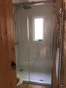 a shower with a glass door in a bathroom at Devoke Water in Elterwater +5 photos