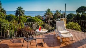 a patio with two chairs and a table with at Hotel Villa Flora in Bogliasco