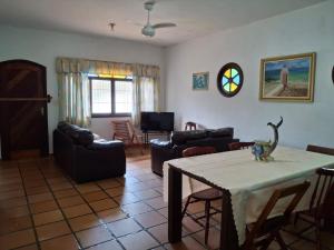 a living room with a table with a dinosaur on it at Casa no Guaraú - Peruíbe in Peruíbe