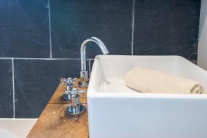 a sink in a bathroom with a sink at Bangeston Farmhouse in Pembroke +32 photos