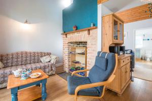 a living room with a couch and a table at Green Meadow in Haverfordwest +28 photos