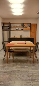 a table in a room with two chairs around it at Idyllische Wohnung im Wienerwald in Vienna +10 photos