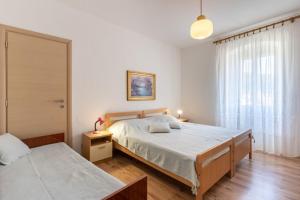 Posteľ alebo postele v izbe v ubytovaní Apartment Mici 1