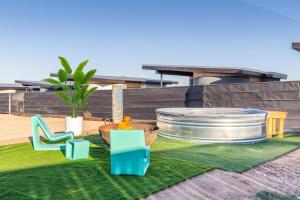 a backyard with a lawn with chairs and a fountain at Casita 4 Cisco Home at The Halles Artisan Venue in Round Top