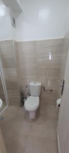 a small bathroom with a toilet and a sink at Appartement Sofia in Martil +24 photos