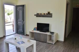 a living room with a tv and a table at Villa Vicky in Petra