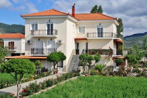 a large white house with balconies and a yard at Villa Vicky in Petra