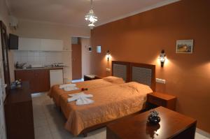 a bedroom with a large bed with towels on it at Villa Vicky in Petra +48 photos