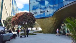 a group of people walking outside of a building at Pullman Auckland Airport in Auckland