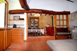 a kitchen and dining room with a table and chairs at Casa Mindela Farmhouse in Vila do Conde