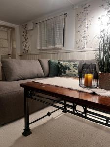 a living room with a couch and a coffee table at Hoda Apartment - Cozy central apartment with free parking in Leknes