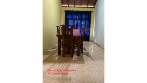 a dining room with two chairs and a table at Pappi's Chateau - 4 min walk to beach in Ambalangoda
