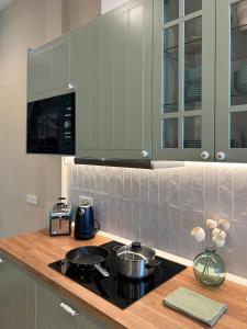 a kitchen with a stove and a counter top at Apartamento Centro Madrid Atocha in Madrid +16 photos