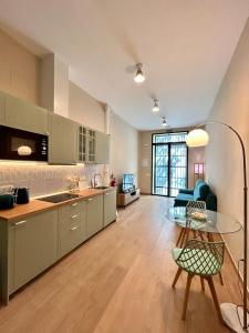 a kitchen and living room with a glass table at Apartamento Centro Madrid Atocha in Madrid