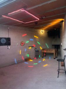 a room with a ping pong table and a wall with confetti at Albergue turistico diversion sur in Horcajo de Santiago