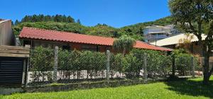 a fence in front of a house at Cantinho de Zimbros in Bombinhas