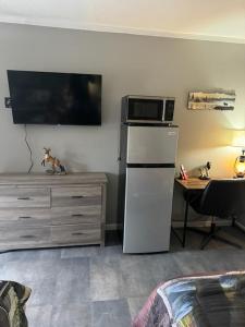 a kitchen with a microwave on top of a refrigerator at White's Motel & Sports Lounge in Centerville +4 photos