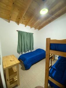 ビージャ・ヤカントにあるCasitas Del Champaquiの二段ベッド2台とテーブルのある寝室