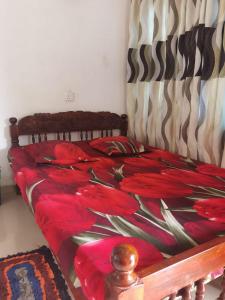 a bed with a red comforter on it at Mount view Safari Lodge - Yala in Kataragama +10 photos