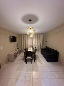 a living room with a table and a couch at Apart Moderno Céntrico 2 Dormitorios 5 Personas in Santiago del Estero
