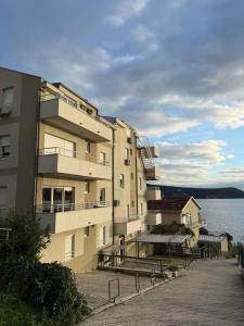 een gebouw naast een waterlichaam bij Savina apartment Herceg Novi in Herceg-Novi