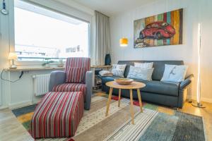 a living room with a couch and a table at Apartmenthaus Dünenburg Dünenburg App 31 in Westerland (Sylt)
