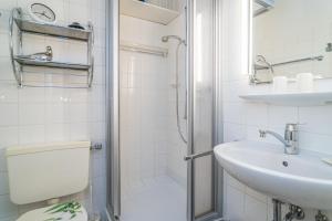 a bathroom with a shower and a sink and a toilet at Wilhelmine 26 in Westerland (Sylt)