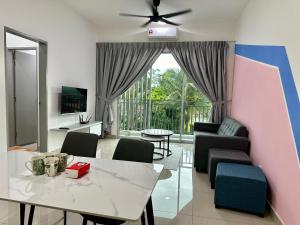 a living room with a white table and a couch at Bayu Temiang Homestay in Seremban