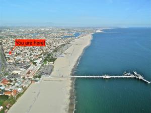 an aerial view of a beach with a bridge at Beach Villa * Hot Tub * Steps to Beach in Long Beach